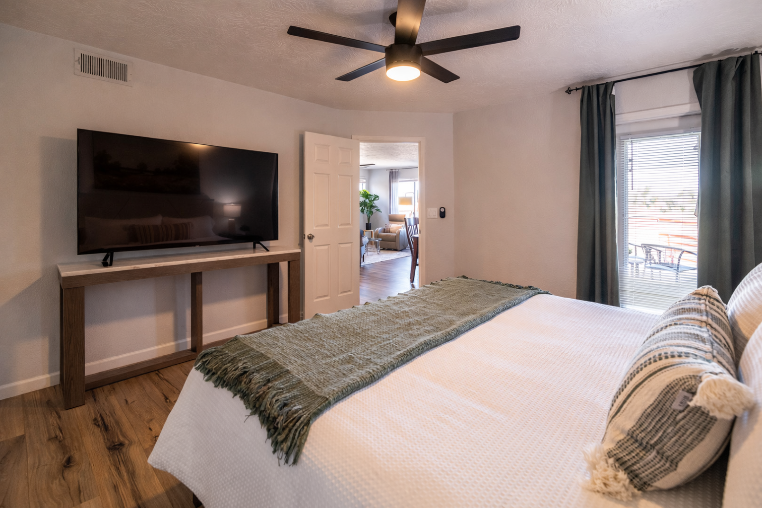 Sink into crisp white linens and enjoy your favorite shows on the flat-screen TV in this serene bedroom retreat.