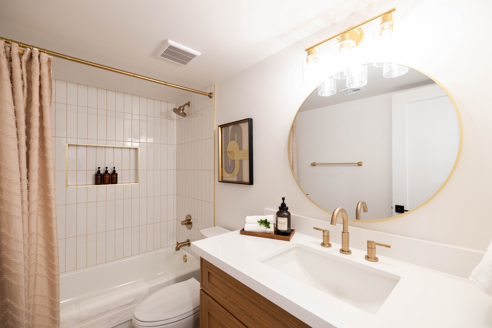 Unwind in this beautifully appointed bathroom featuring gold-accents and a soak-in tub.