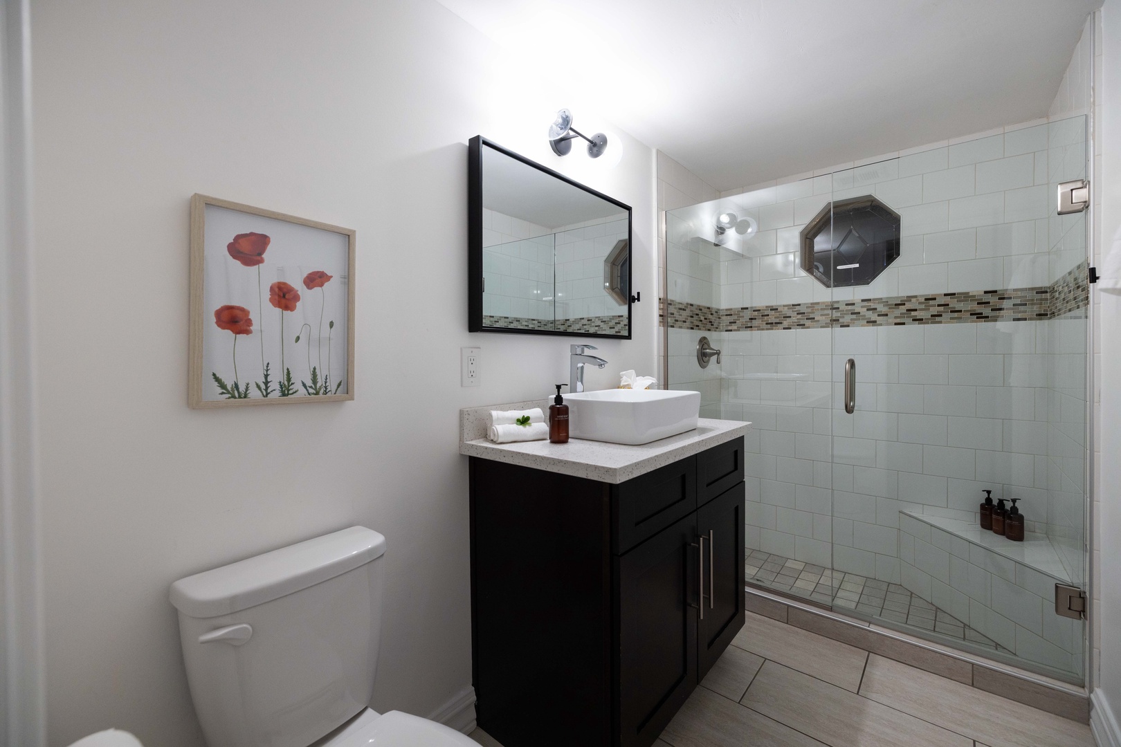 Step into your beautifully appointed bathroom with a spacious walk-in shower featuring elegant tile work and a modern vessel sink that adds a touch of sophistication to your daily routine.