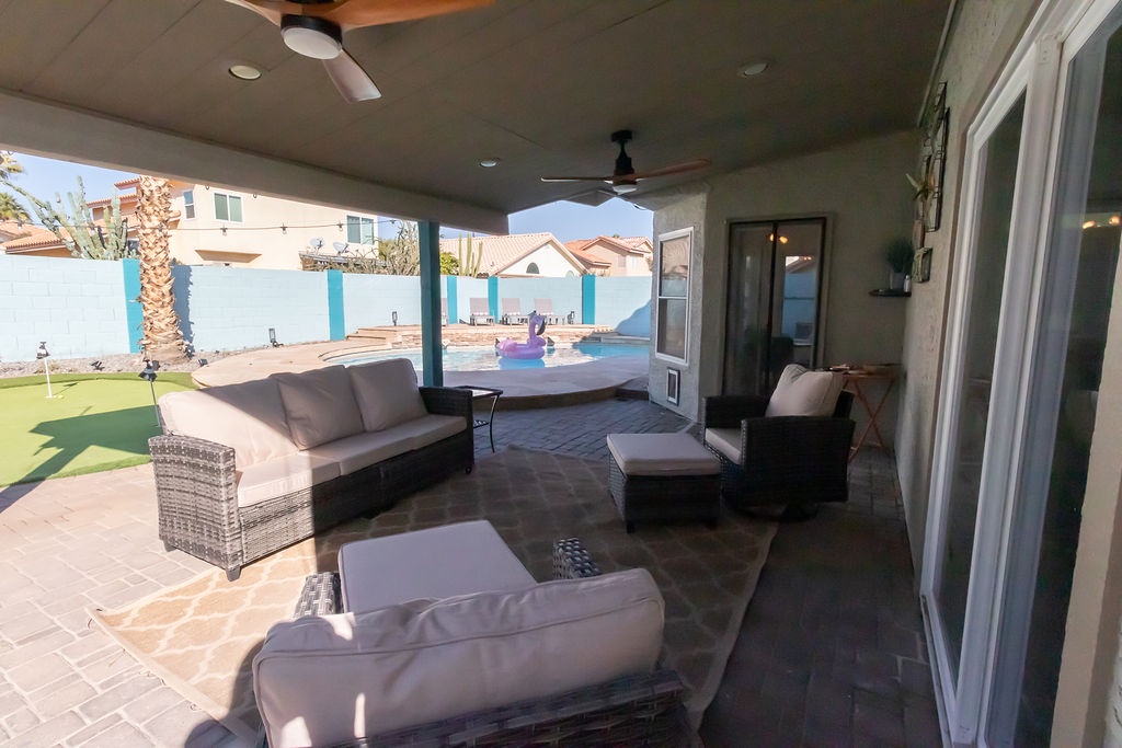 Step onto your private covered patio where plush seating awaits. Ceiling fans keep you cool as you gaze at the sparkling pool and lush desert landscaping beyond.