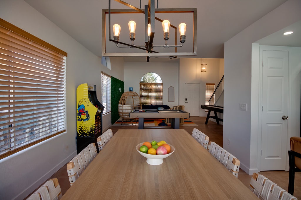 Your spacious dining area features a statement chandelier and connects to your game room with arcade fun and ping pong.