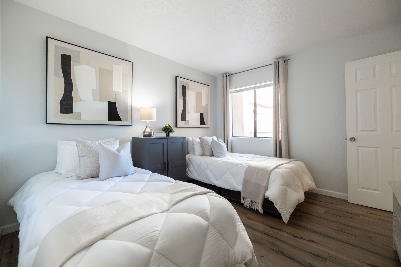 Rest peacefully in this serene twin bedroom with plush white linens