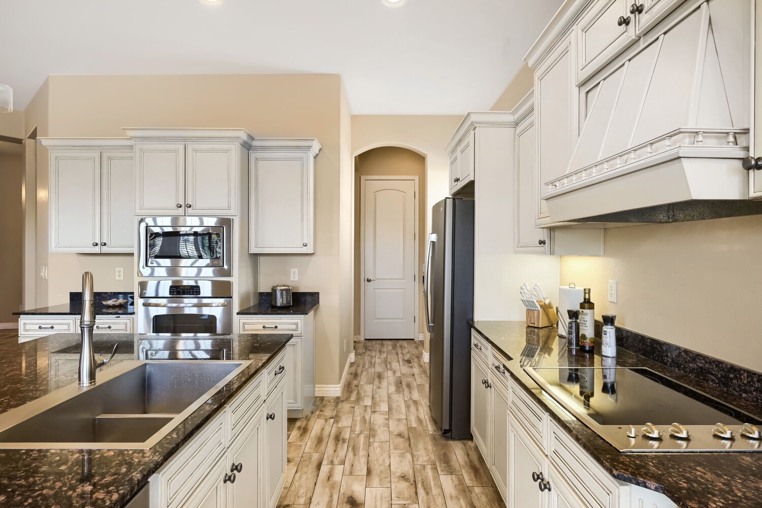 Step into your fully equipped gourmet kitchen, where crisp white cabinetry meets sleek granite countertops. Everything you need to whip up memorable meals is right at your fingertips.
