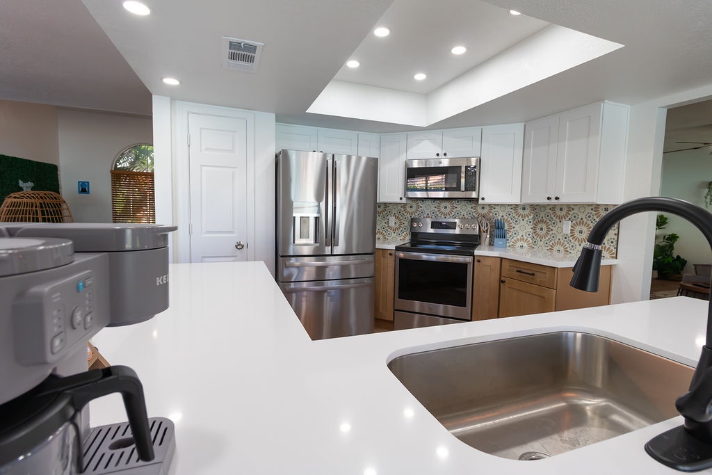 Your fully-equipped modern kitchen features gleaming quartz countertops, stainless steel appliances, and everything you need to create memorable meals.