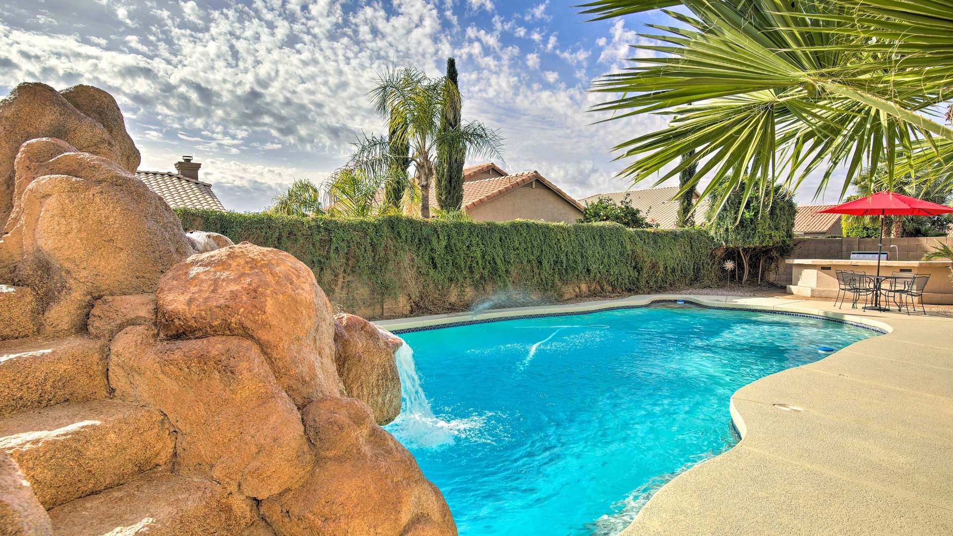 Dive into your private oasis featuring a sparkling pool with a waterslide