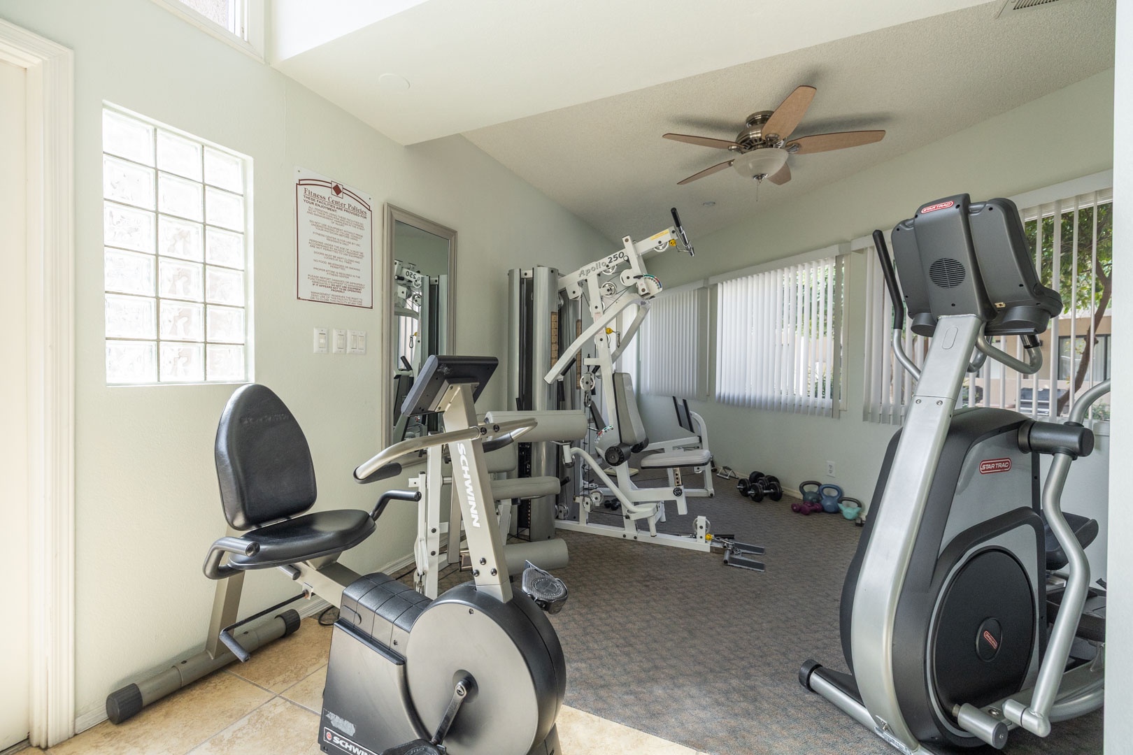 Your fitness room awaits with cardio equipment and strength training stations, all bathed in natural light for energizing workouts.