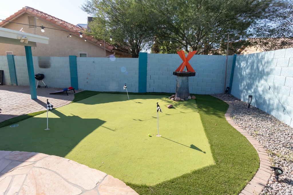 Practice your putting skills on your private miniature golf course in the sunny backyard.