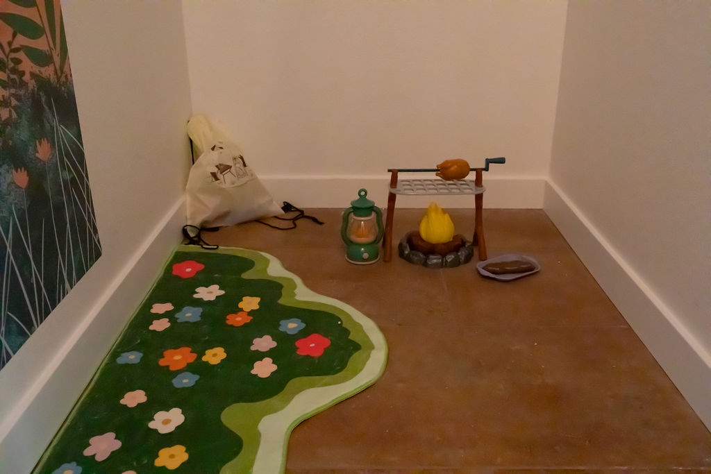 Your little ones will love this charming play corner, complete with camping toys and a colorful flower rug for imaginative adventures.