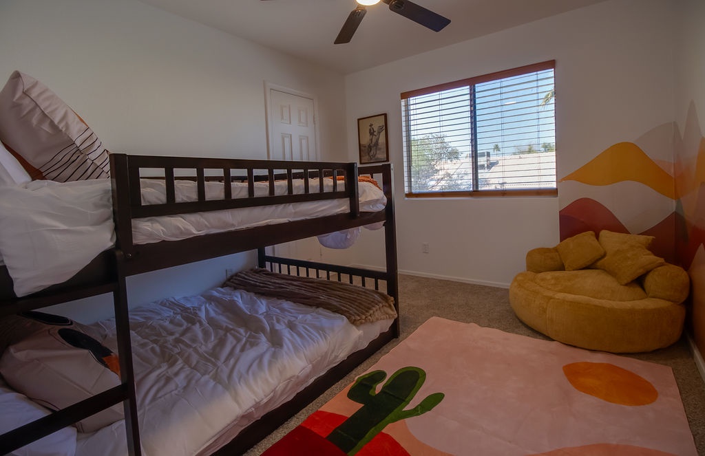 Your kids will love this fun bedroom with bunk beds and a cozy yellow bean bag for relaxing after adventure-filled days.