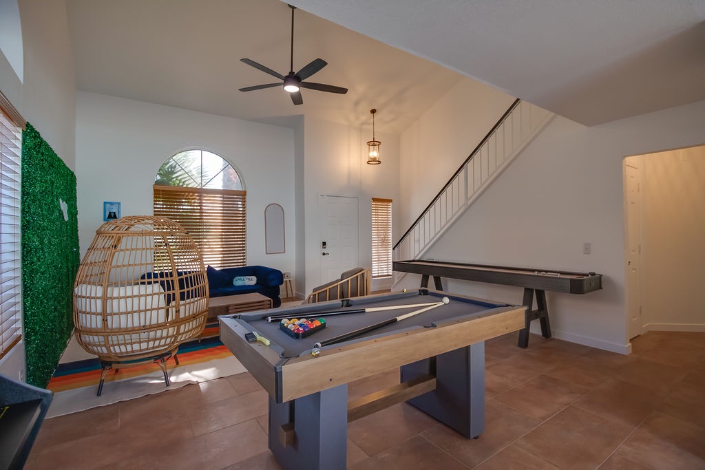 Challenge friends to pool while relaxing in your unique hanging chair—this spacious game room offers endless entertainment.