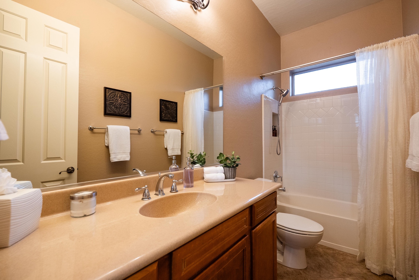 Shared hallway bath with tub and handheld shower