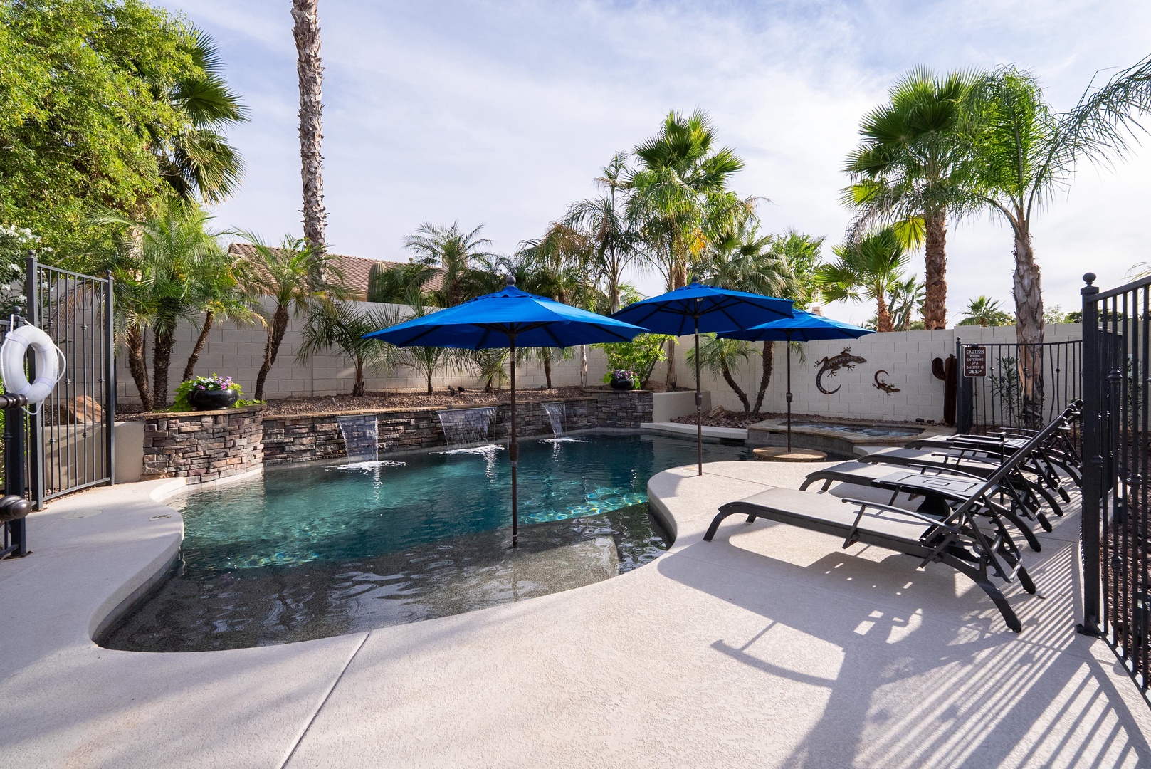 Fenced heated pool with 4 lounge chairs to soak in the sun
