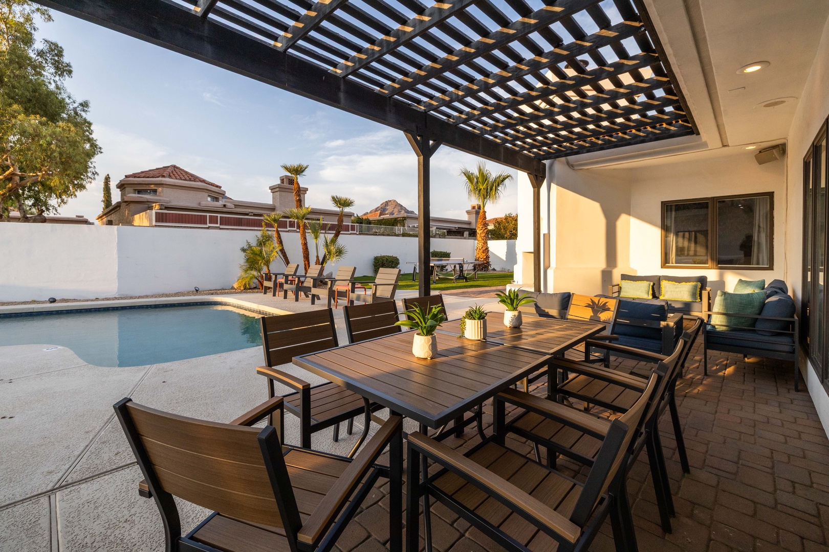 Step out to a shaded pergola, sparkling pool, and poolside seating