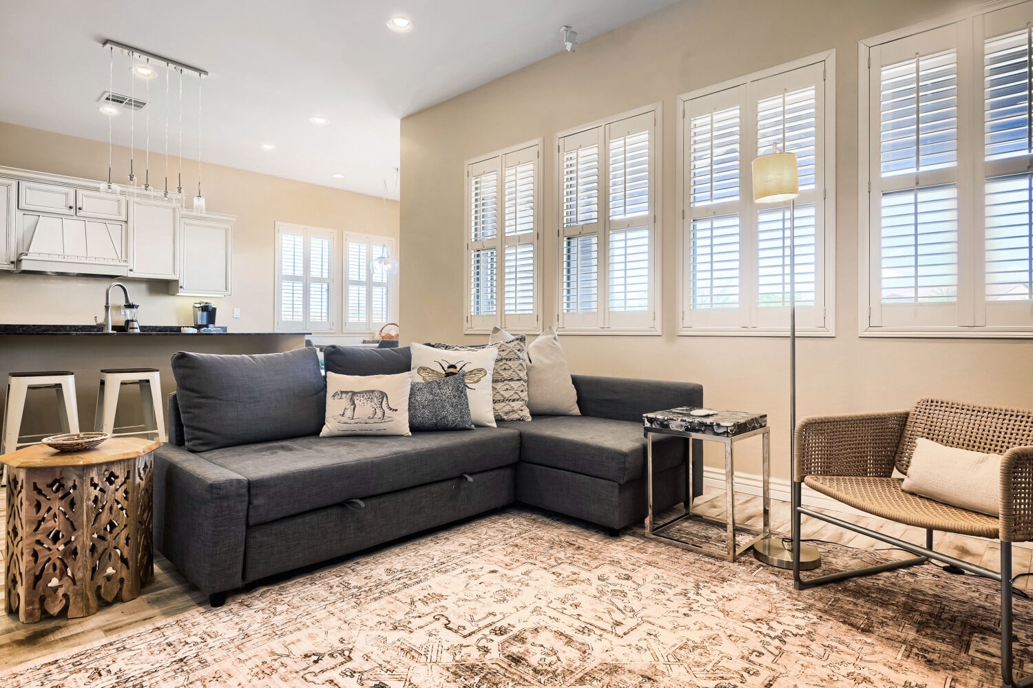 Sink into the plush sectional and feel right at home in this bright, airy living space. Elegant shutters frame natural light while cozy touches invite you to unwind after exploring.