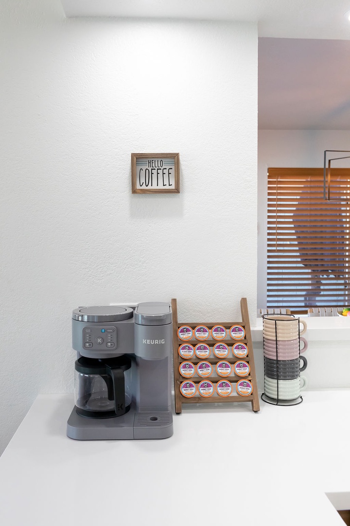 Start your morning right with your own coffee station featuring a Keurig machine and variety of K-cups ready for brewing.
