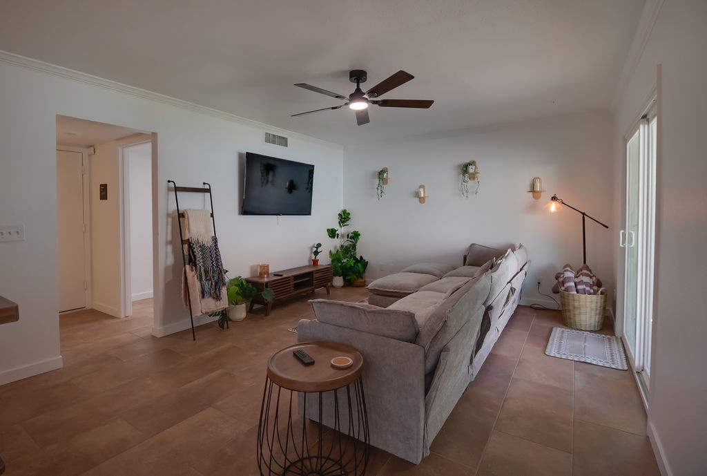 Unwind in your stylish living room with plush sectional seating, modern entertainment, and thoughtful touches that make this space feel like home.