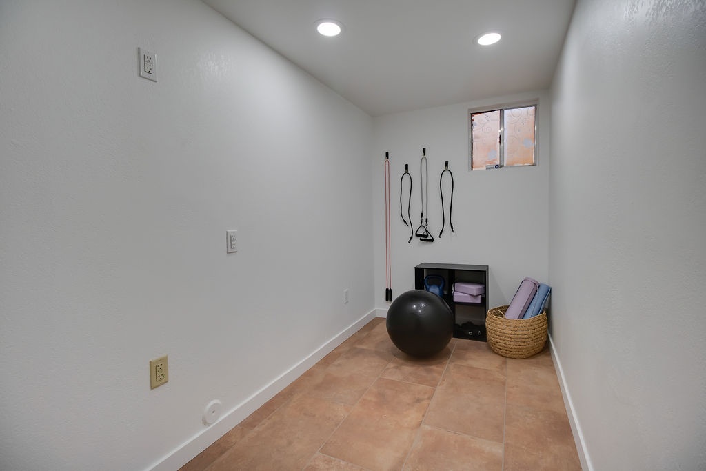 Your private fitness space awaits with yoga mats, exercise ball, and resistance bands ready for energizing workouts.