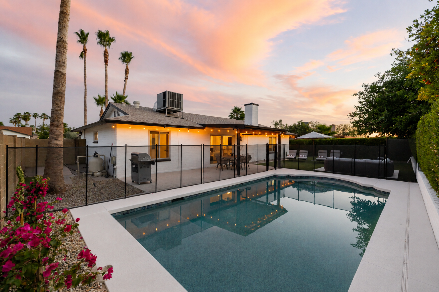 Golden hour magic - fenced heated pool, string lights, and palm trees for unforgettable Arizona evenings