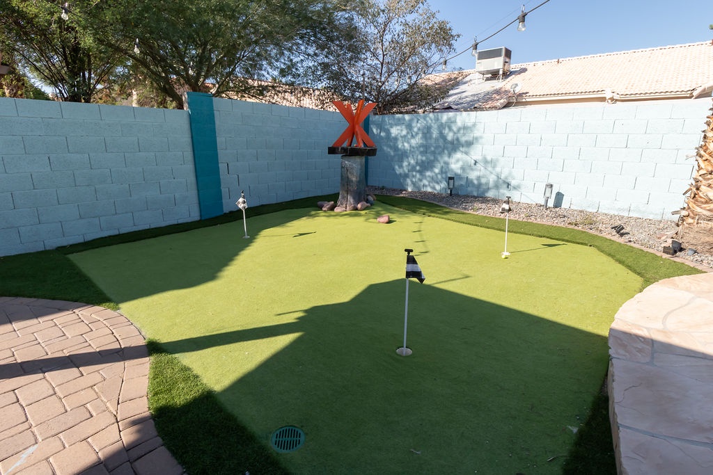 Practice your putting skills on your own private mini golf course in this secluded backyard paradise.