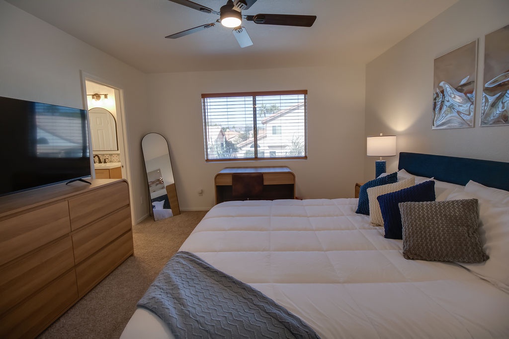 Your peaceful bedroom features crisp linens, modern furnishings, and a ceiling fan to keep you comfortable.
