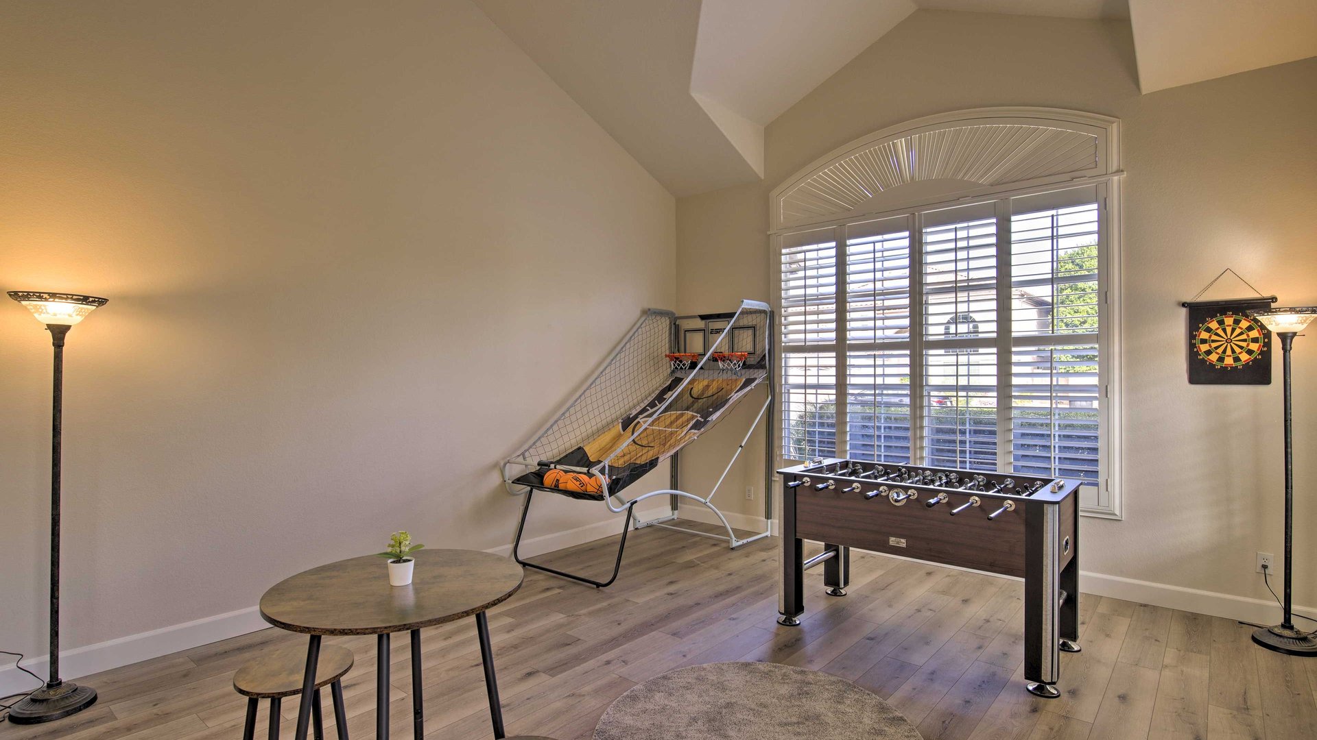 Unwind in your private game room featuring foosball, basketball, and darts