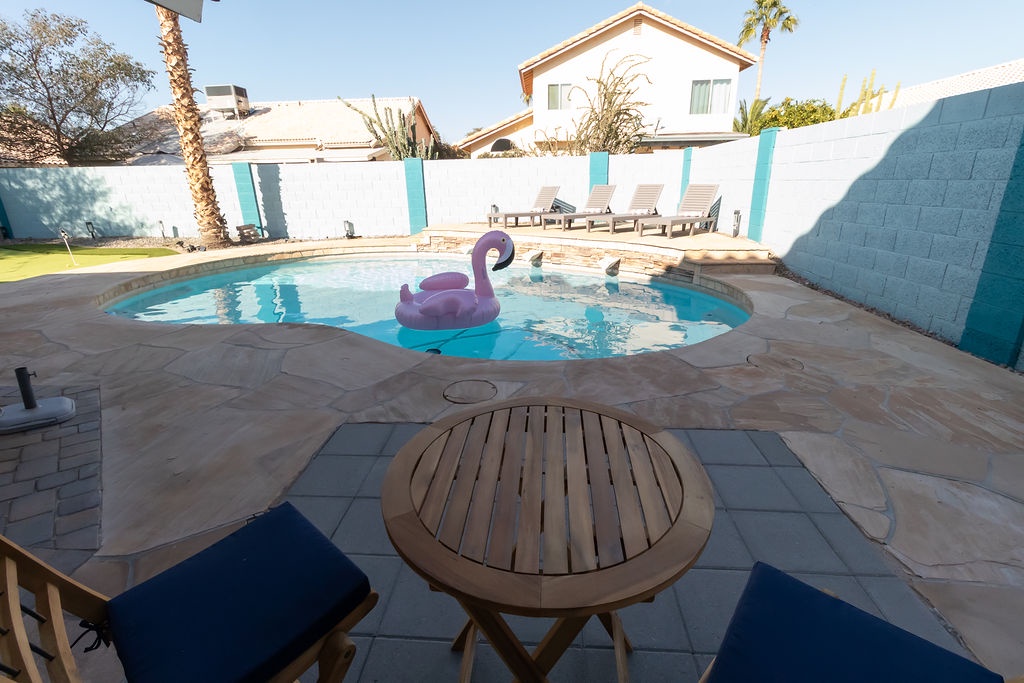 Dive into your private oasis with a sparkling pool, cozy seating area, and playful flamingo float waiting for sunny afternoon relaxation.
