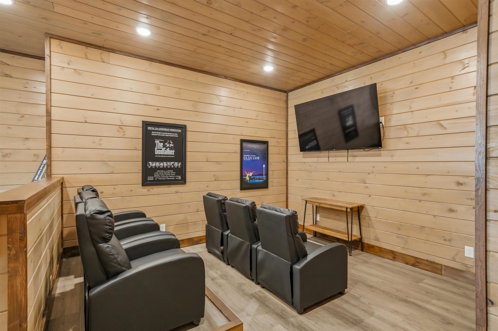 Settle into plush leather recliners for your private movie nights in this cozy home theater with warm wood paneling and big-screen entertainment.
