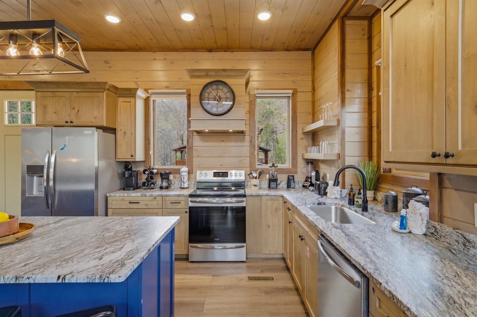 Cook memorable meals in your fully equipped kitchen featuring granite countertops, stainless appliances, and warm wood finishes.