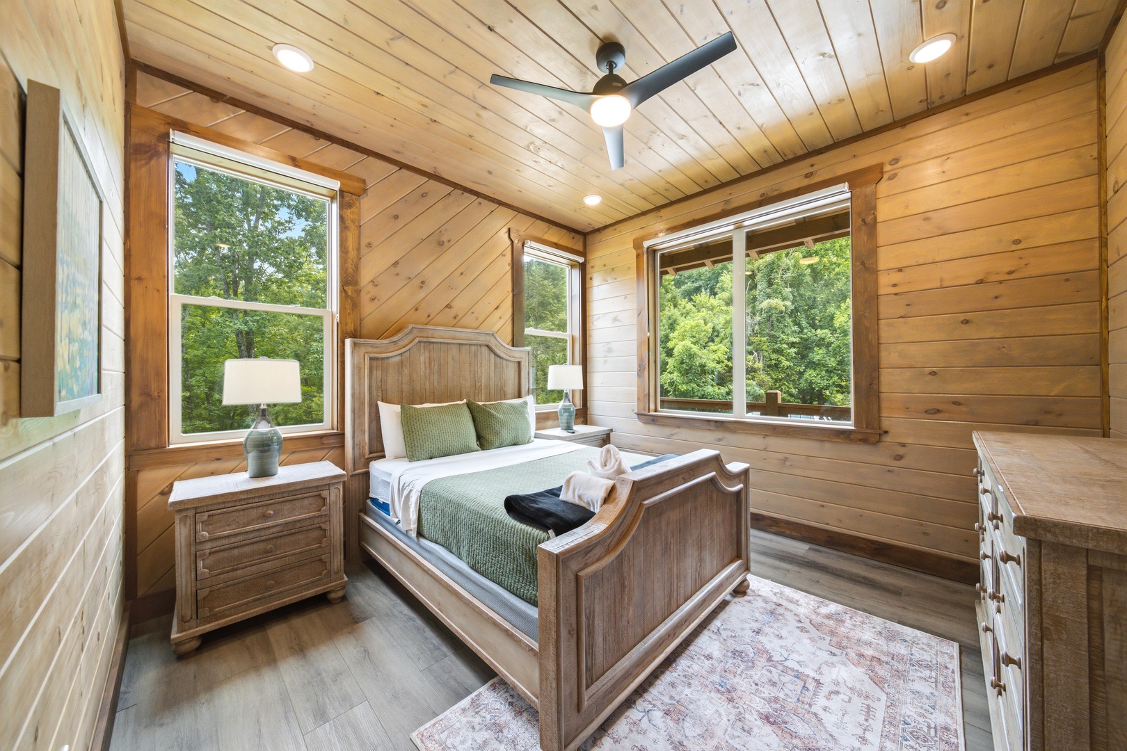 Wake up surrounded by warm wood and natural light streaming through your windows. Your cozy retreat overlooks lush greenery, inviting you to unwind in complete tranquility.