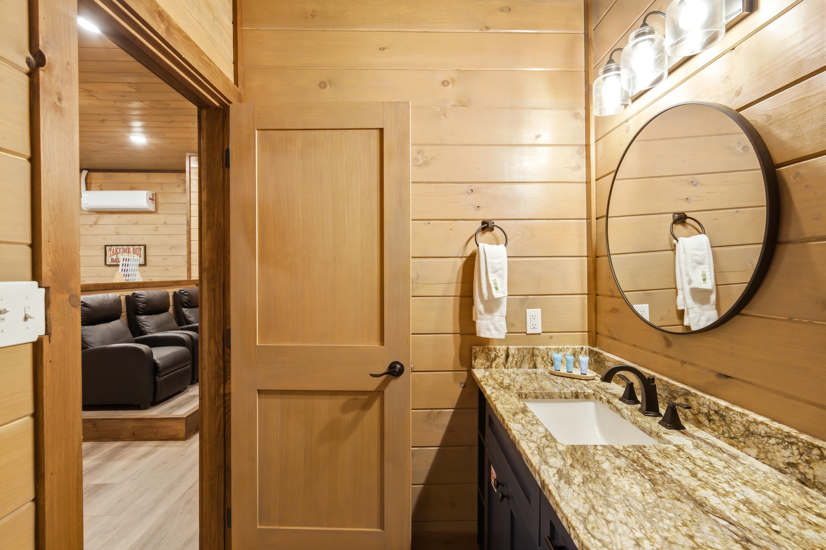 Refresh in this warm, wood-paneled bathroom featuring granite countertops, modern fixtures, and soft towels—a perfect retreat after your mountain adventures.