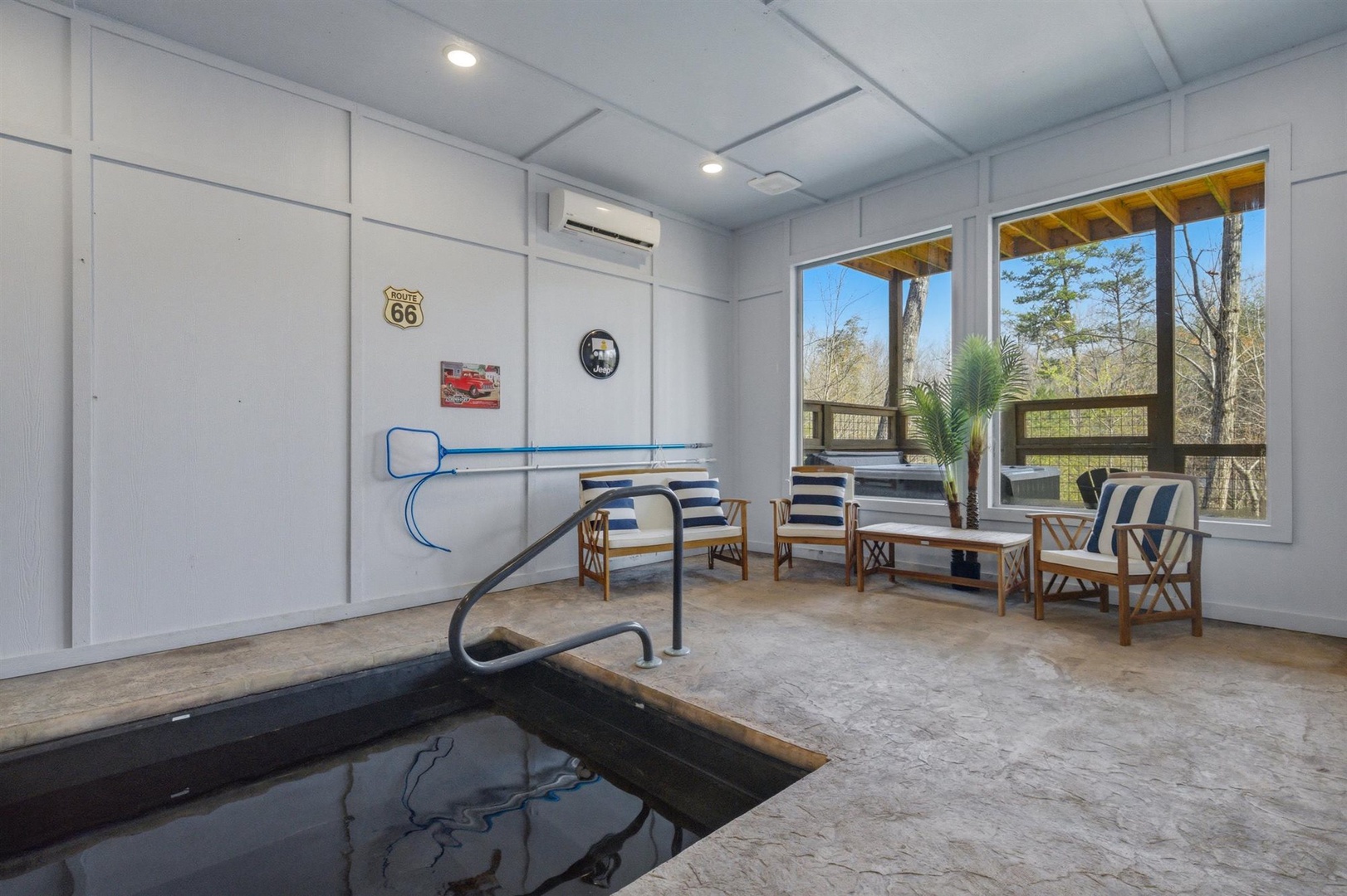 Unwind in your private spa room featuring a therapeutic plunge pool and comfortable seating where you can relax while enjoying peaceful forest views.