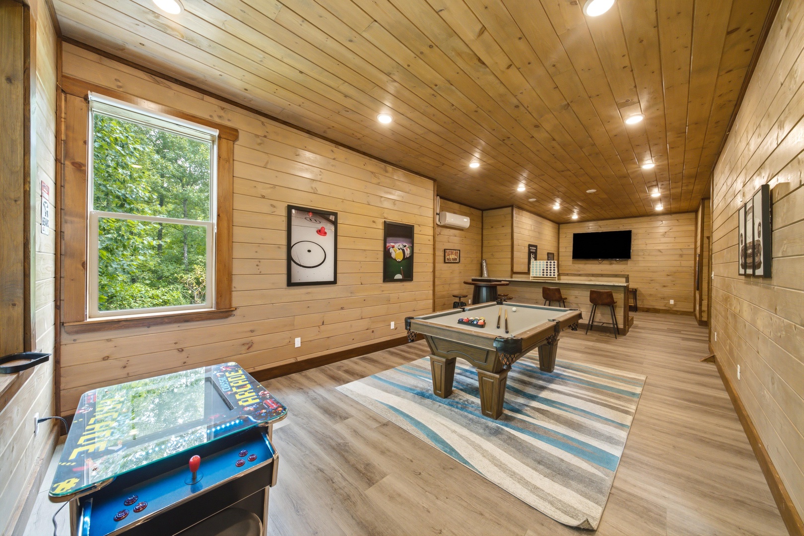 Challenge your friends to a pool game or try the arcade—your own game room awaits with warm wood walls and plenty of space to unwind after exploring.