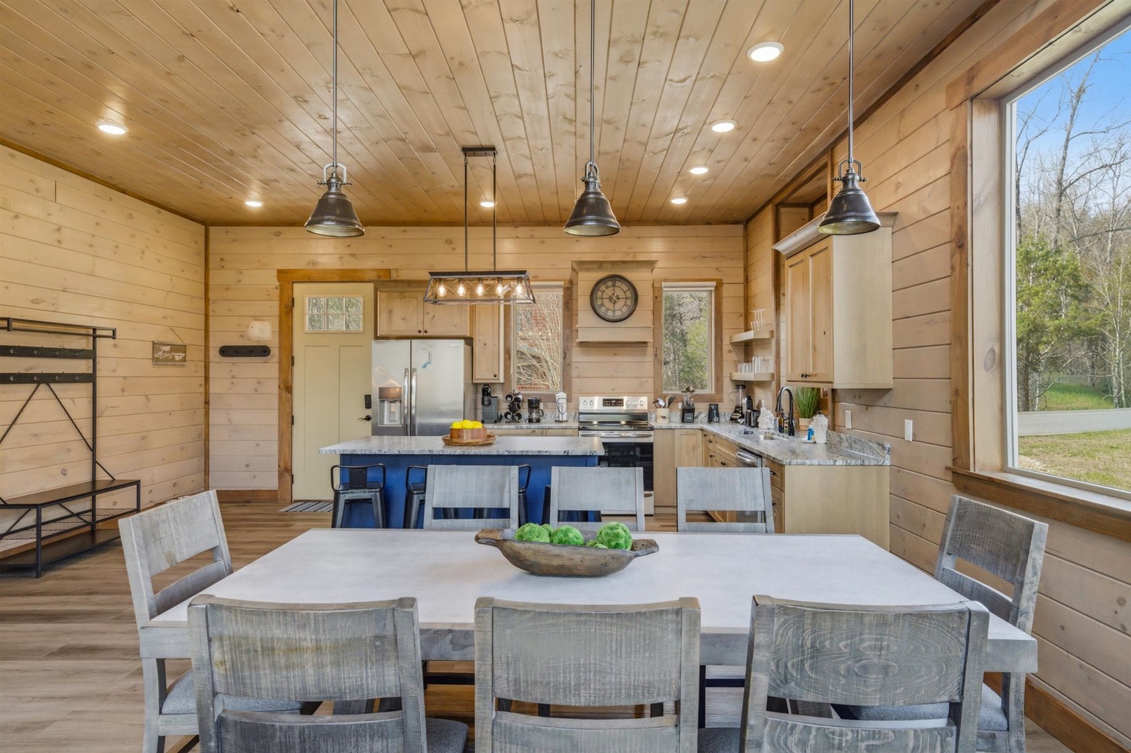 Gather around this spacious dining table while meals are prepared in your fully-equipped kitchen with modern appliances and rustic charm.