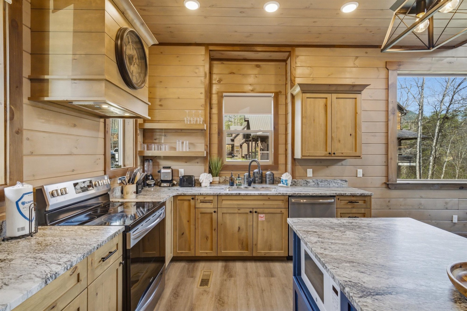 Your rustic mountain kitchen features granite counters, stainless appliances, and warm wood cabinets perfect for preparing memorable meals together.