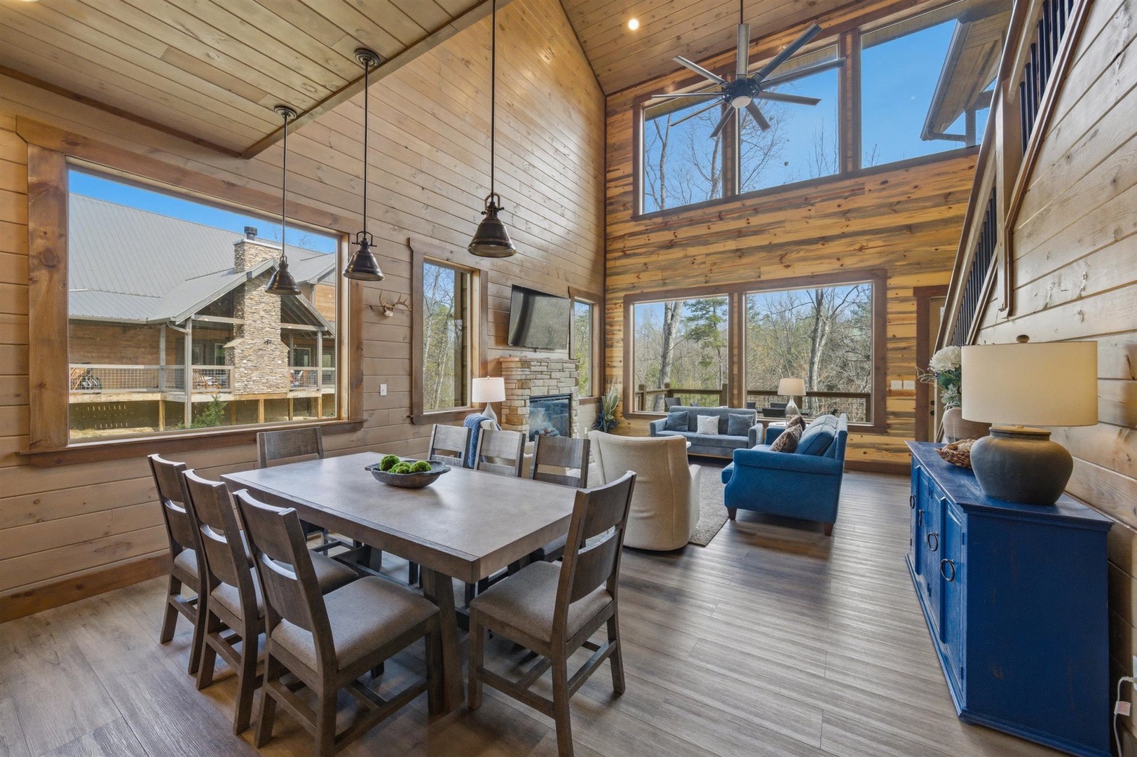 Relax in your stunning open-plan living space with soaring ceilings, exposed beams, and panoramic windows that flood the room with natural light.