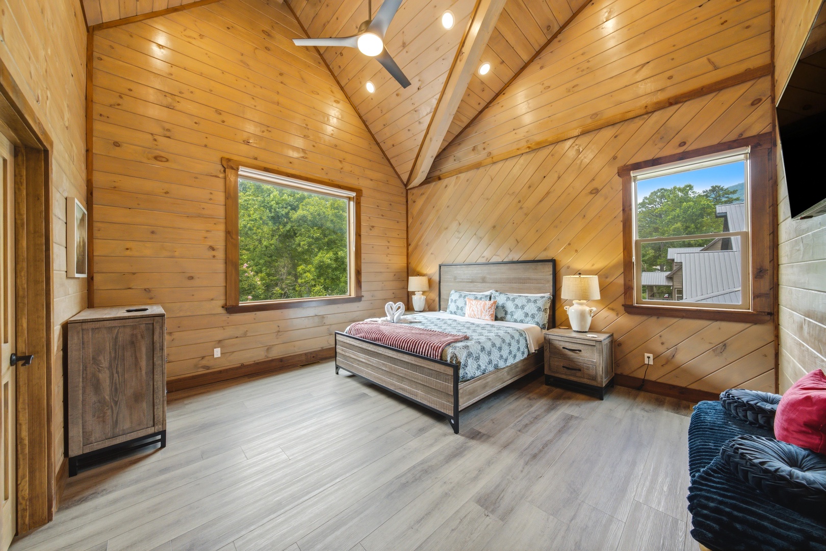 Unwind in your spacious bedroom where warm wood tones and vaulted ceilings create a cozy yet airy retreat, perfect for peaceful mornings and restful nights.