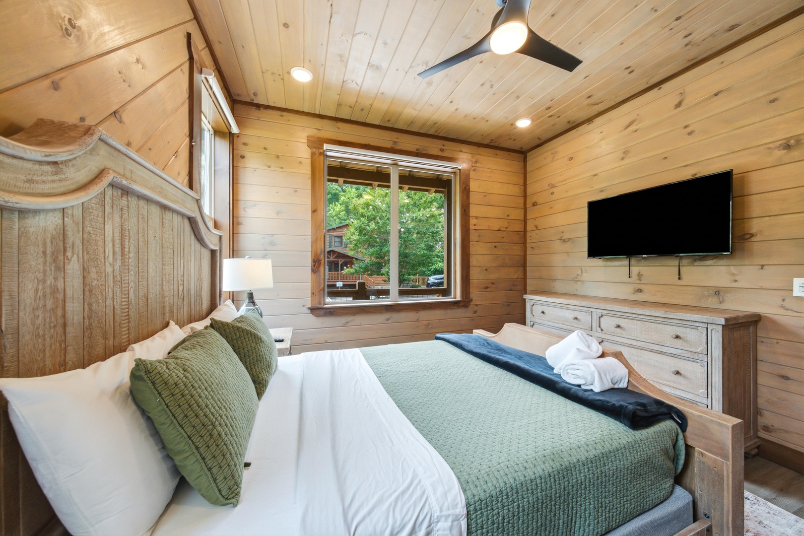 Sink into crisp white linens beneath warm wood beams and catch mountain breezes through your window. Fresh towels await, and the TV is ready for unwinding after your adventures.