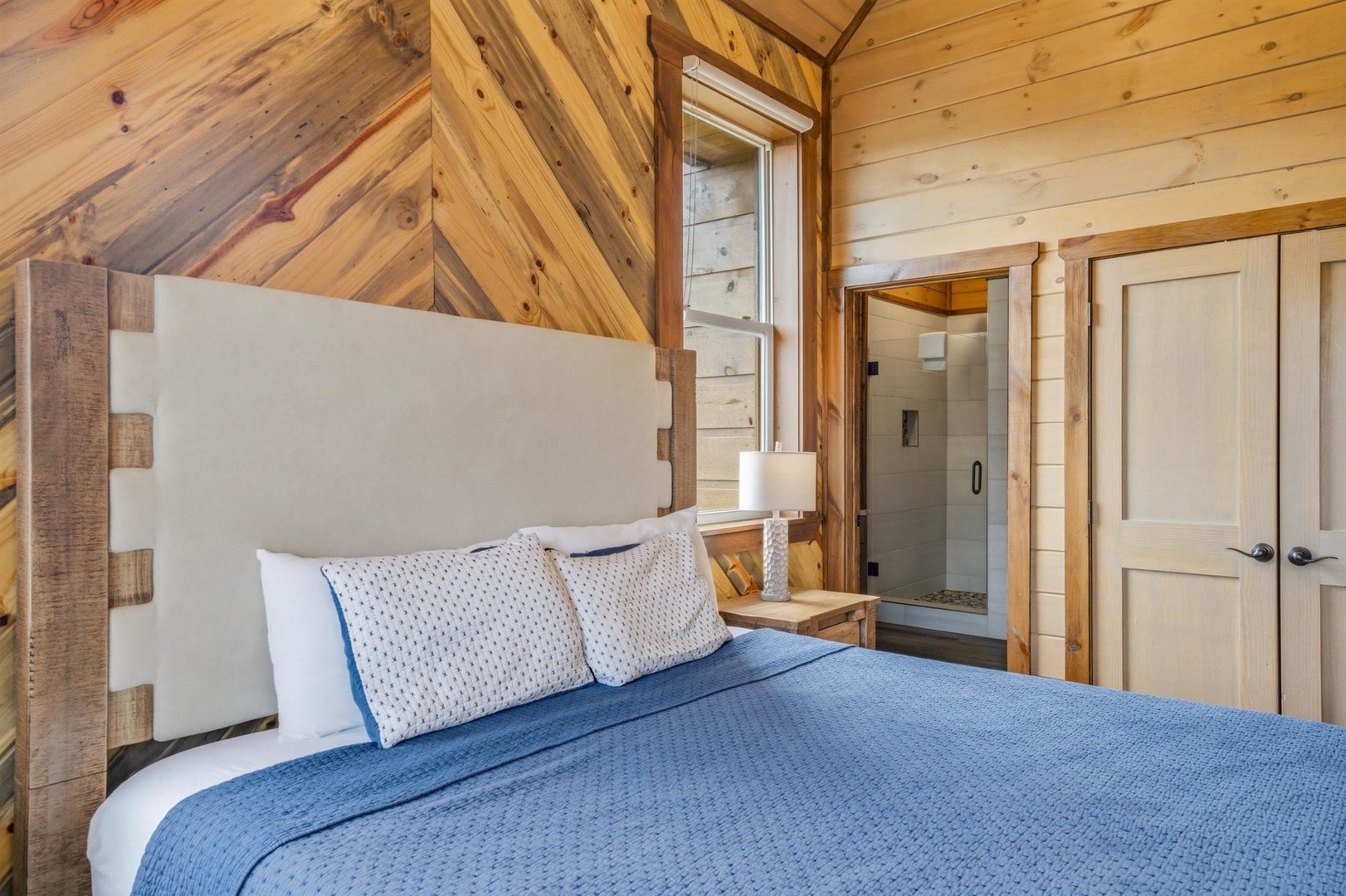 Sink into comfort beneath soaring wooden beams, where rustic charm meets modern luxury in your private retreat.