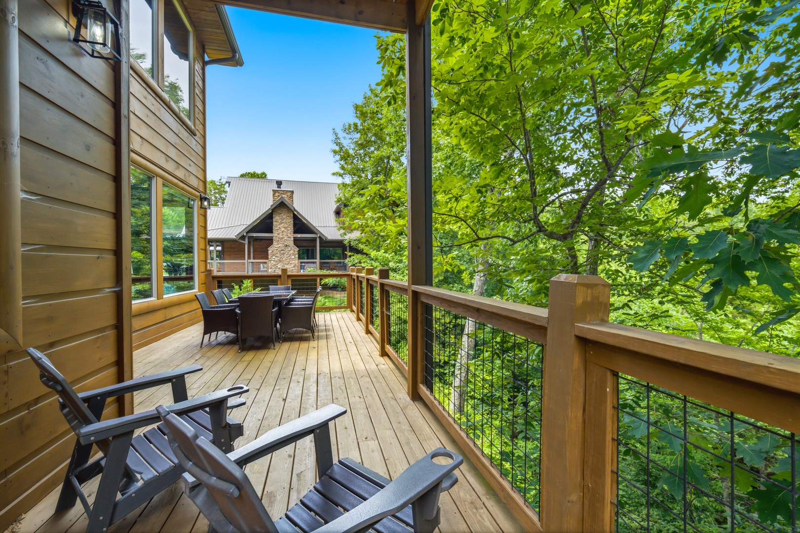 Step onto your private deck and breathe in the fresh forest air. Sink into an Adirondack chair surrounded by vibrant greenery, or gather around the outdoor table for morning coffee with treetop views.