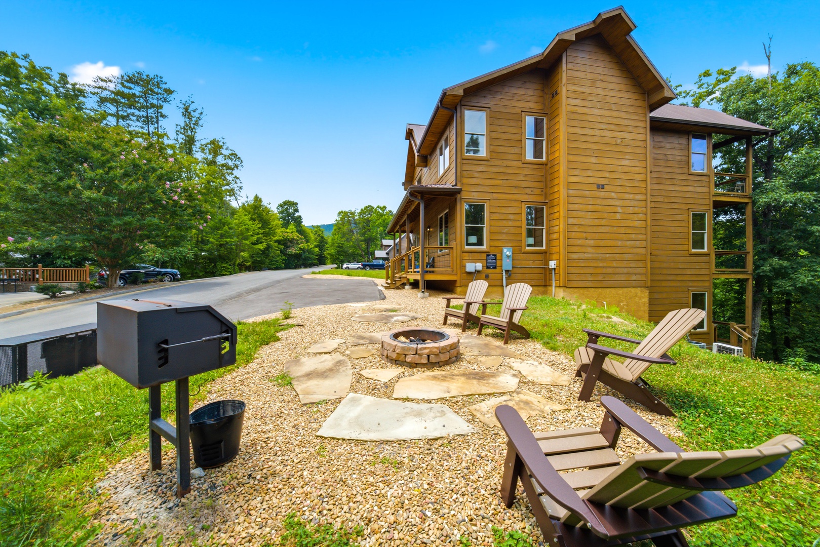 The charming three-story cabin is surrounded by lush greenery and offers a peaceful retreat. Your outdoor fire pit and Adirondack chairs create the perfect setting for memorable evenings under the stars.