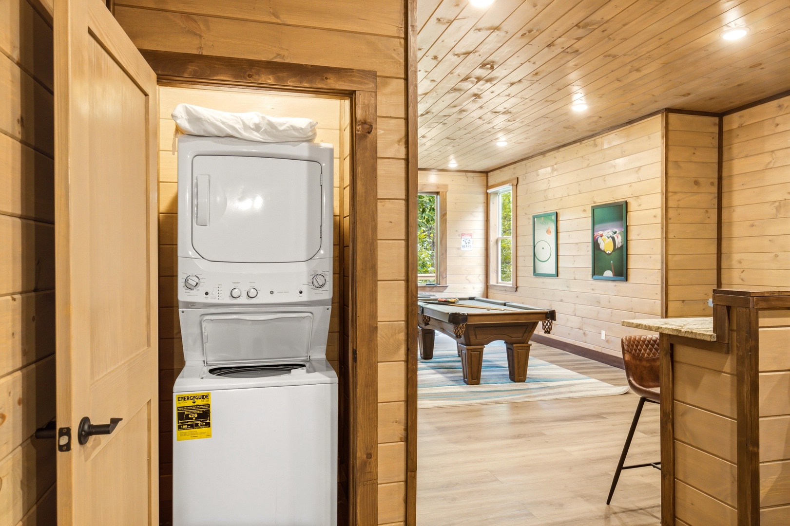 Your washer and dryer combo keeps things convenient, while the billiards table invites friendly competition in the warm, wood-paneled game room.