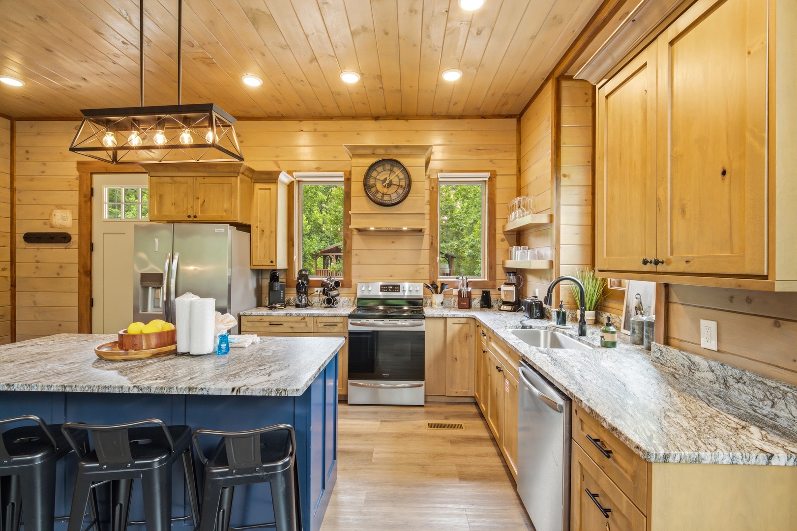 You'll love preparing meals in this spacious kitchen with gleaming granite counters, warm wood finishes, and a gorgeous island perfect for gathering with family and friends.