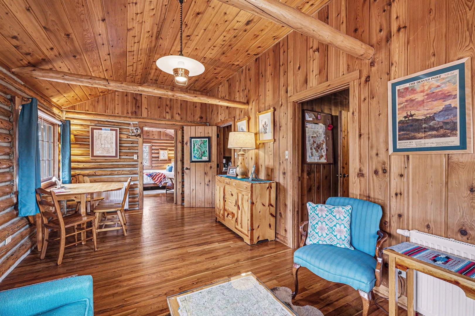 Relax in this charming log cabin with hand hewn log walls throughout, cozy seating, and rustic dining nook perfect for your mountain retreat.