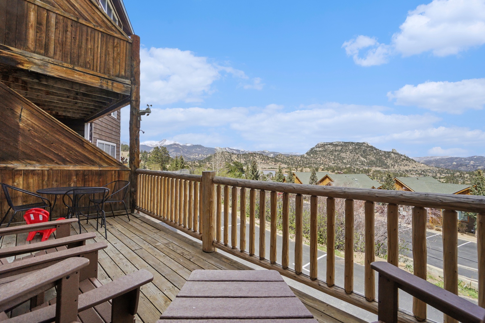 Rustic mountain cabin balcony with stunning views and peaceful outdoor dining for memorable mornings.