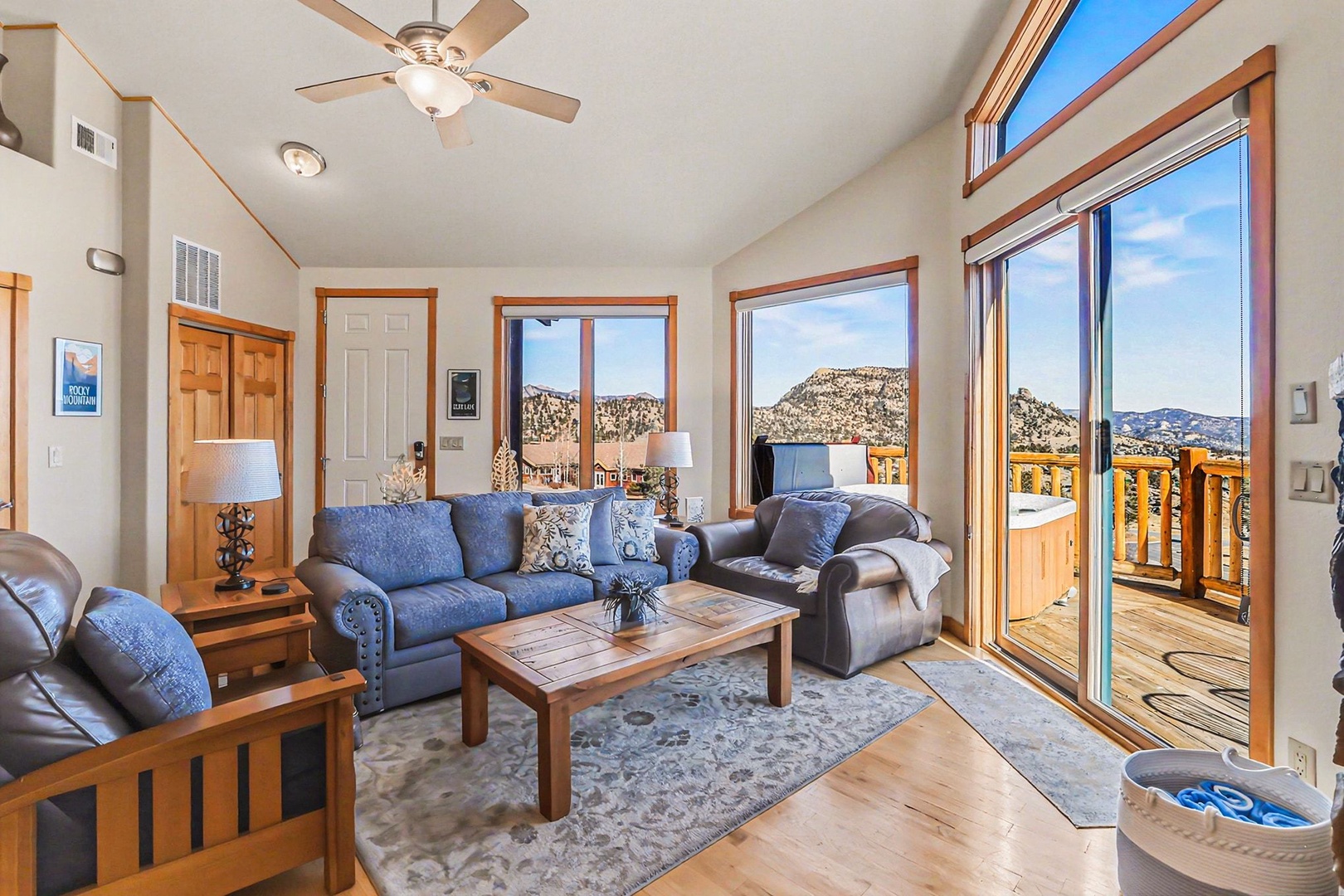 Relax in your bright living room with panoramic mountain views through floor-to-ceiling windows that frame the breathtaking landscape.