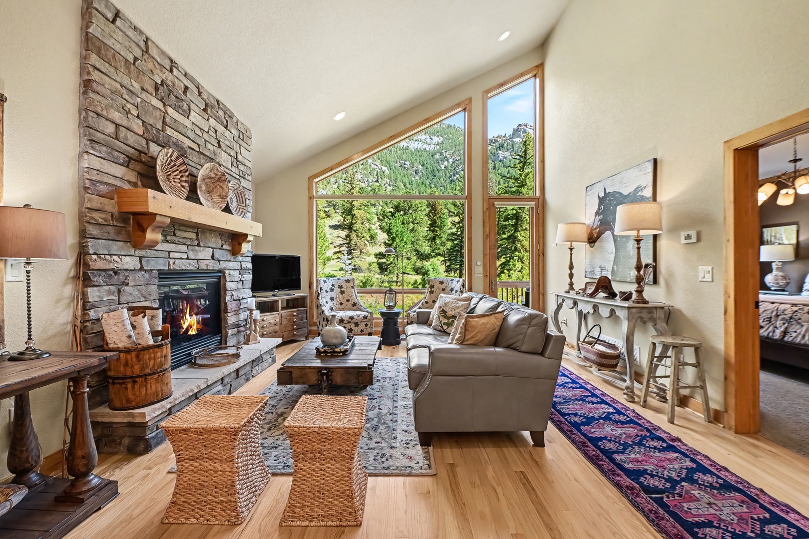 Gather around the stone fireplace in your stunning living room.