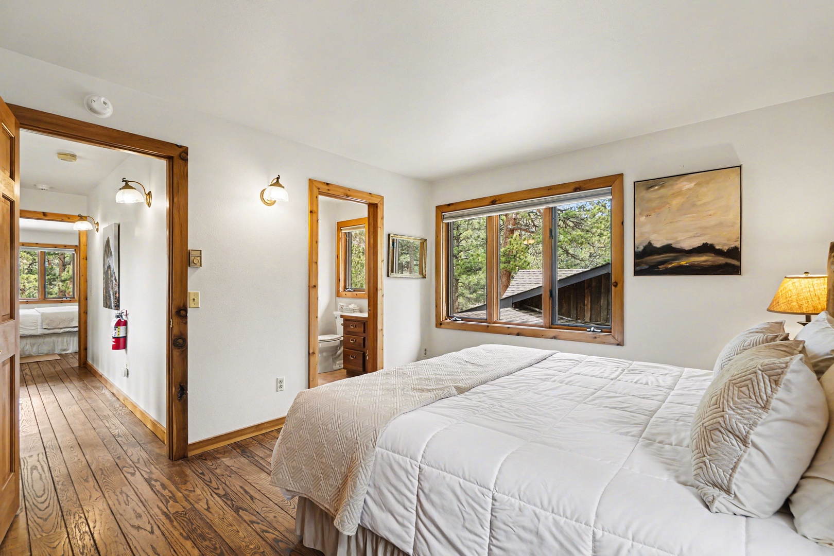 Wake up refreshed in your cozy bedroom, where warm wood tones and soft bedding create the perfect mountain retreat sanctuary.