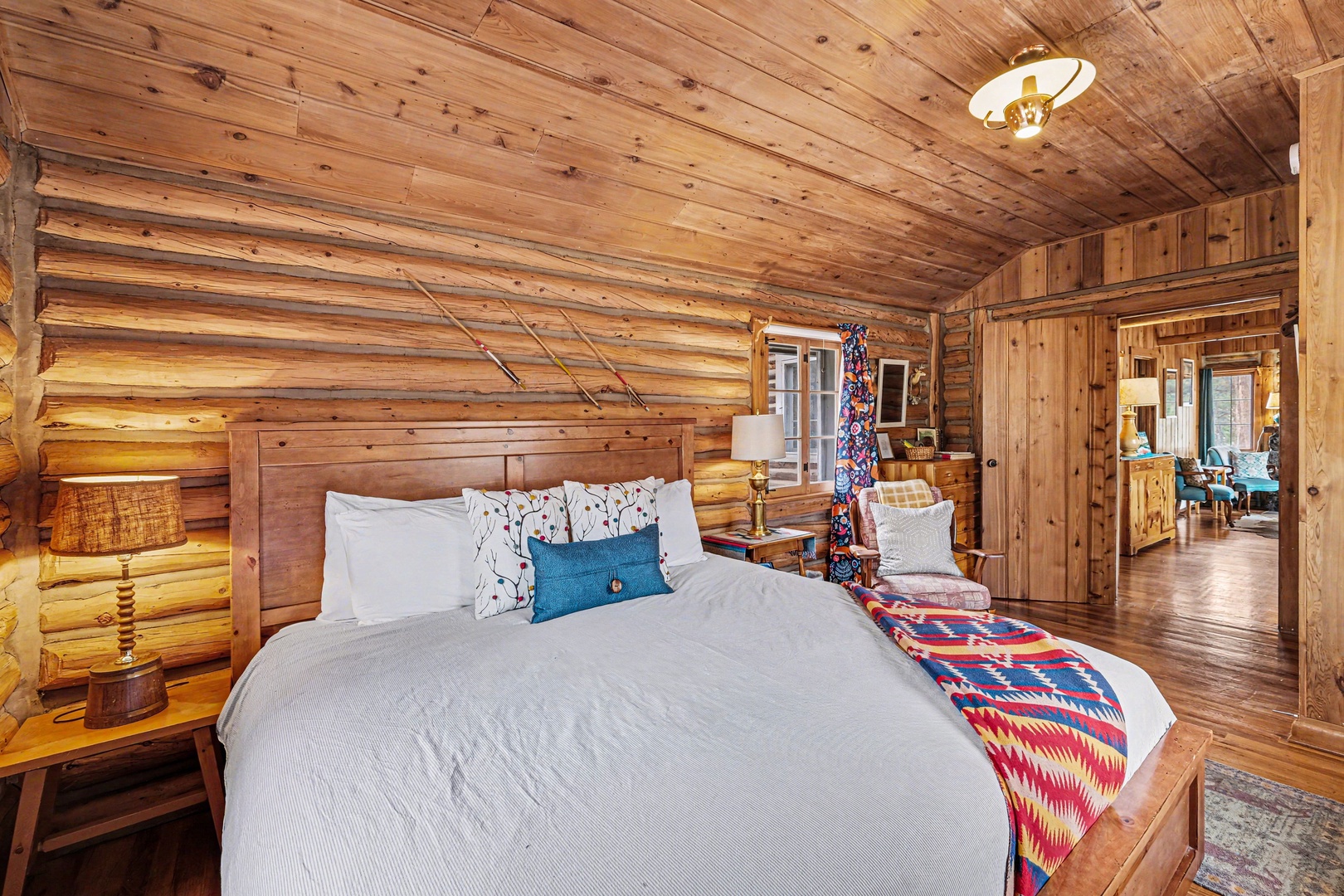 Drift off in this cozy log cabin bedroom where rustic wood beams surround your comfortable bed with crisp linens.