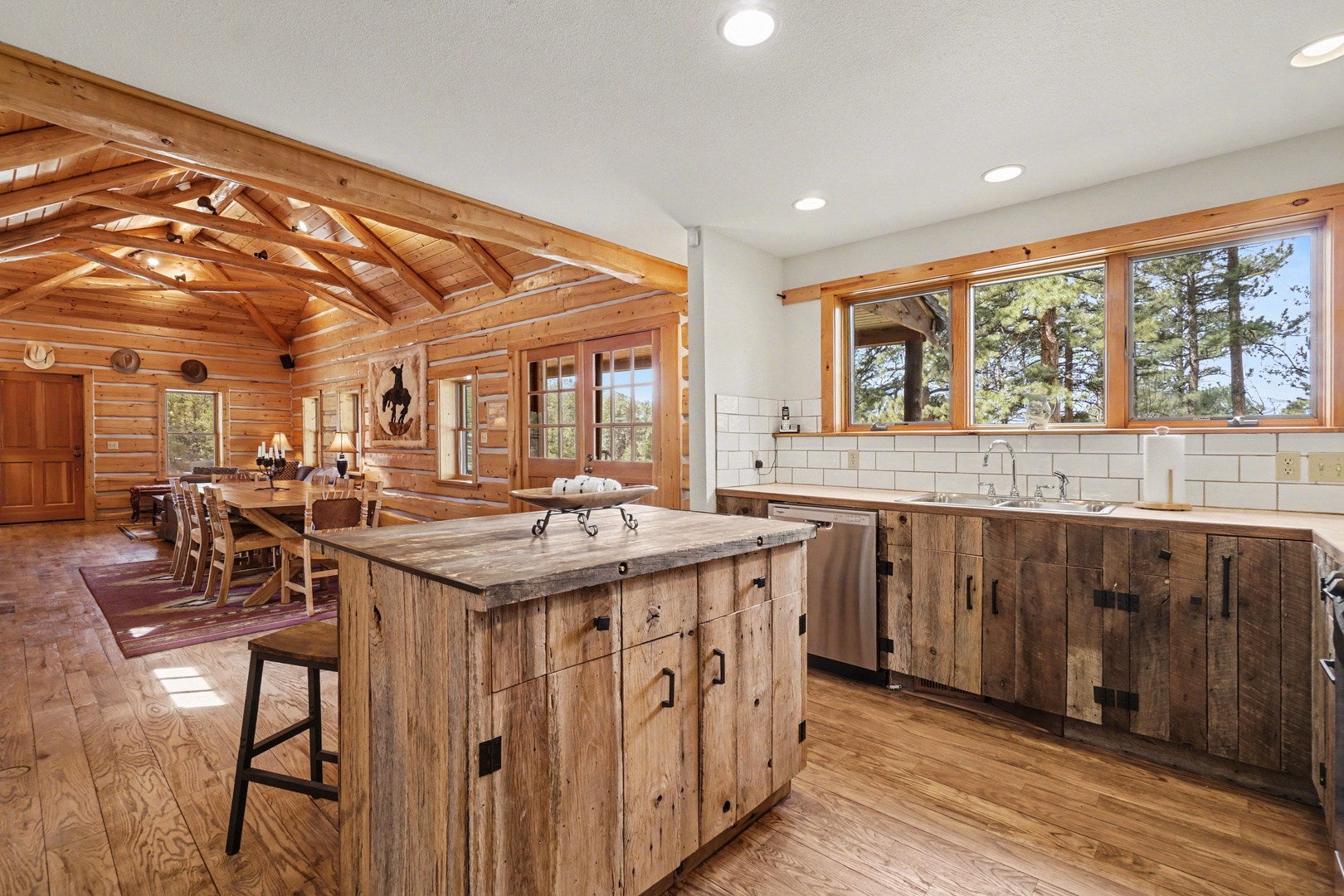 Your rustic kitchen combines reclaimed wood with modern convenience, featuring exposed beams and forest views for memorable meals.