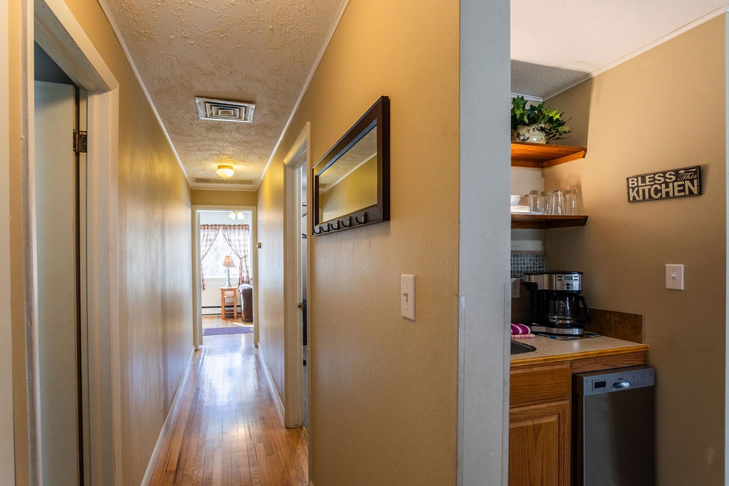 Your cozy hallway connects seamlessly to the well-equipped kitchenette, where morning coffee awaits.